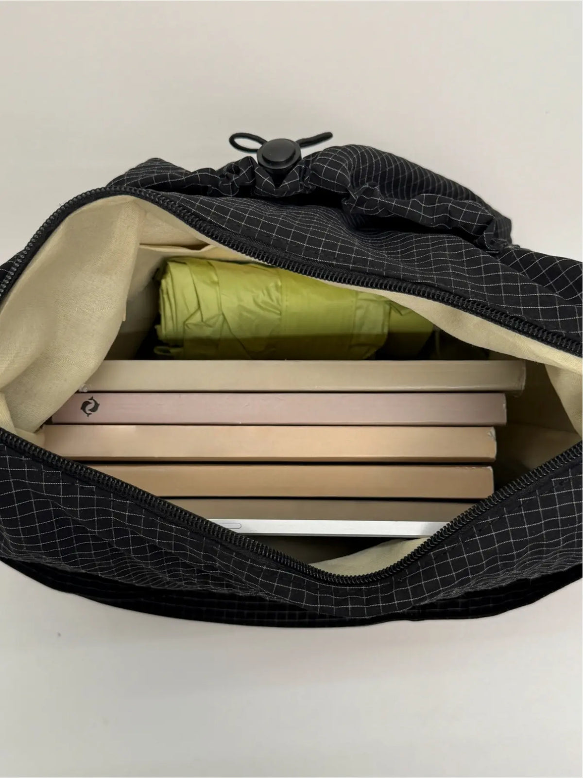 Sloane Plaid Crossbody Bag interior packed with books and tablet