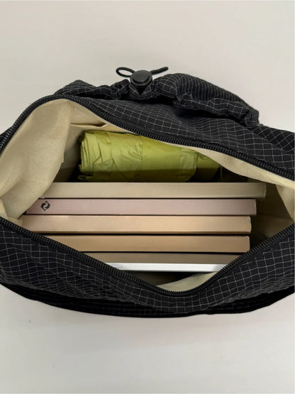 Sloane Plaid Crossbody Bag interior packed with books and tablet