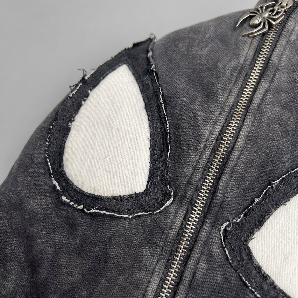 Close up of the stitched spider eye applique on the hood