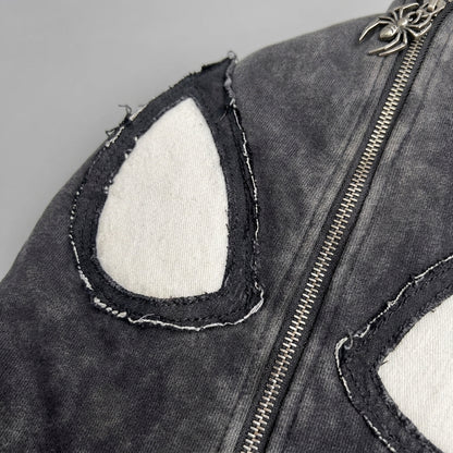 Close up of the stitched spider eye applique on the hood