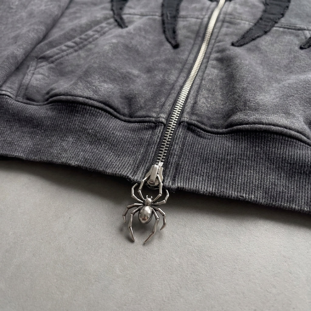 Close up of the spider shaped metal zipper pull