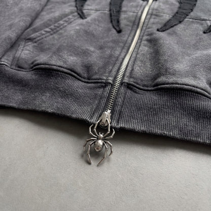 Close up of the spider shaped metal zipper pull