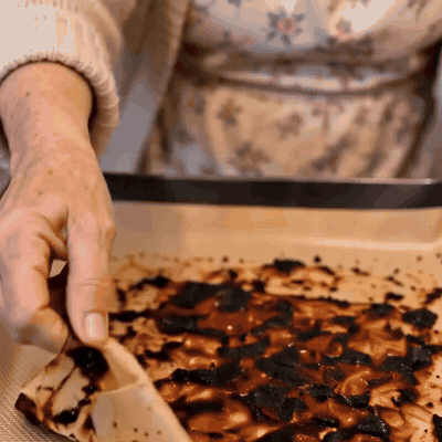 Peeling the baked-on layer off the mat in one piece