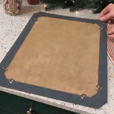 Snapping the mat corners into a raised tray