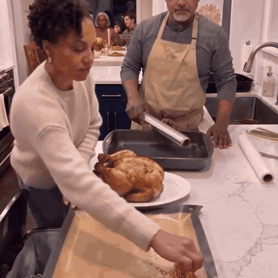 Peeling the mess off the tray and carrying the turkey to the table