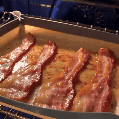 Bacon roasting in the snap tray with the grease held in
