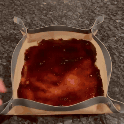 Unsnapping the tray and peeling off the baked-on grease